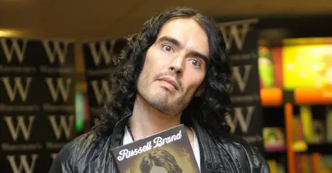 russell brand prosecuted us warner bros execs outtakes victim attacked