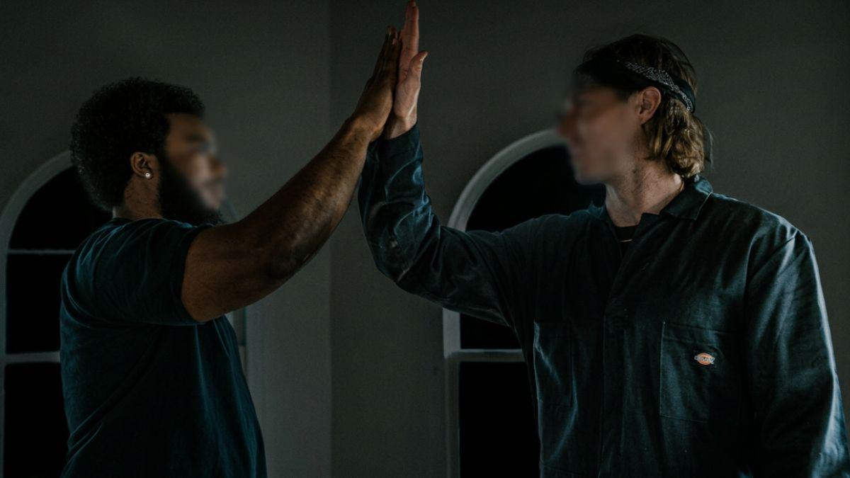 Photo of 2 persons giving high five