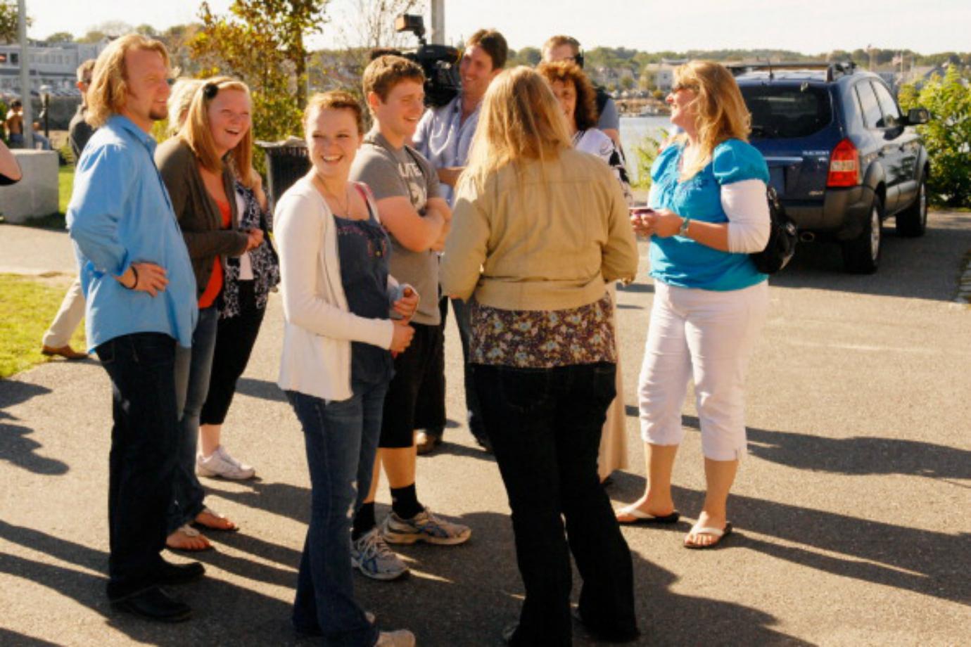 The Brown family of 'Sister Wives' stands in a parking lot.