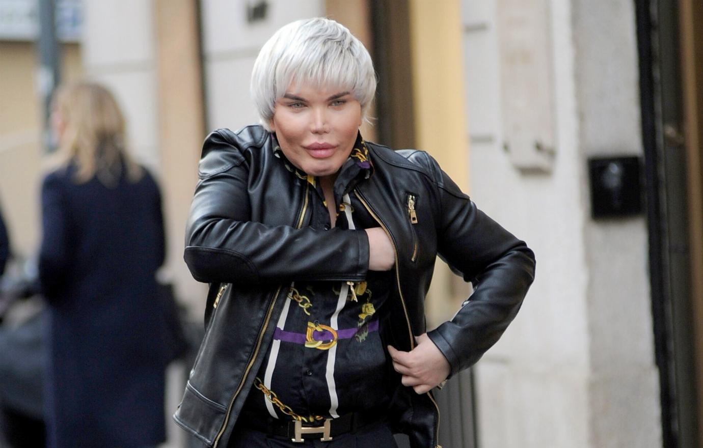 Rodrigo Alves in a black leather jacket, black jeans and patterned black shirt walks down the street.