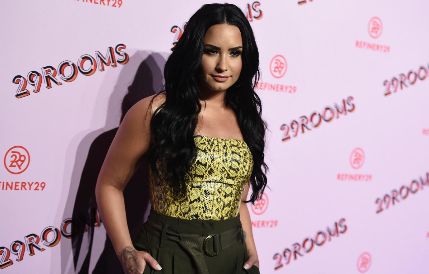 Demi Lovato appeared confident in her reptile-print tube top, tucked into dark slacks.