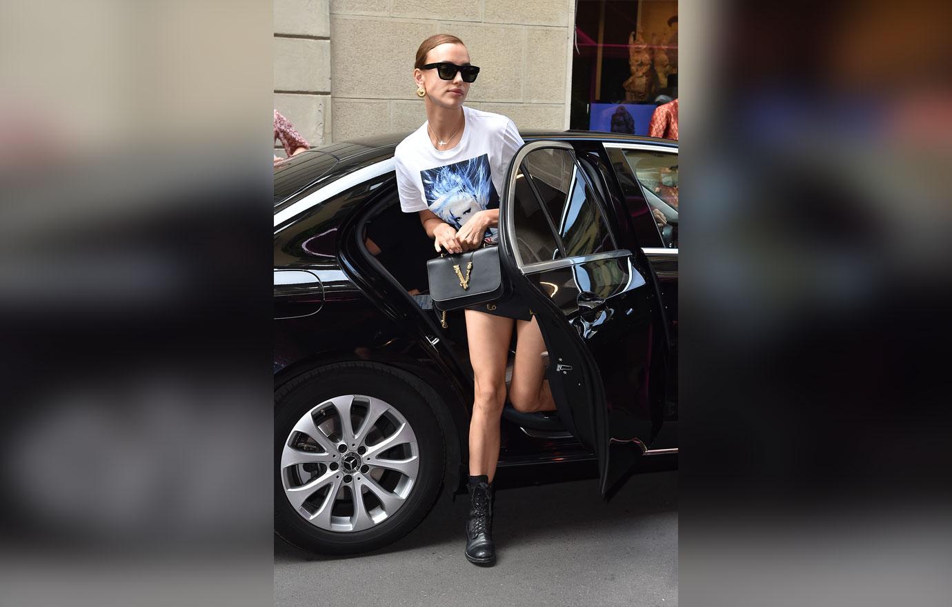 Irina Shayk wears a white shirt with silk screen print with the singer Blondie's face on it.