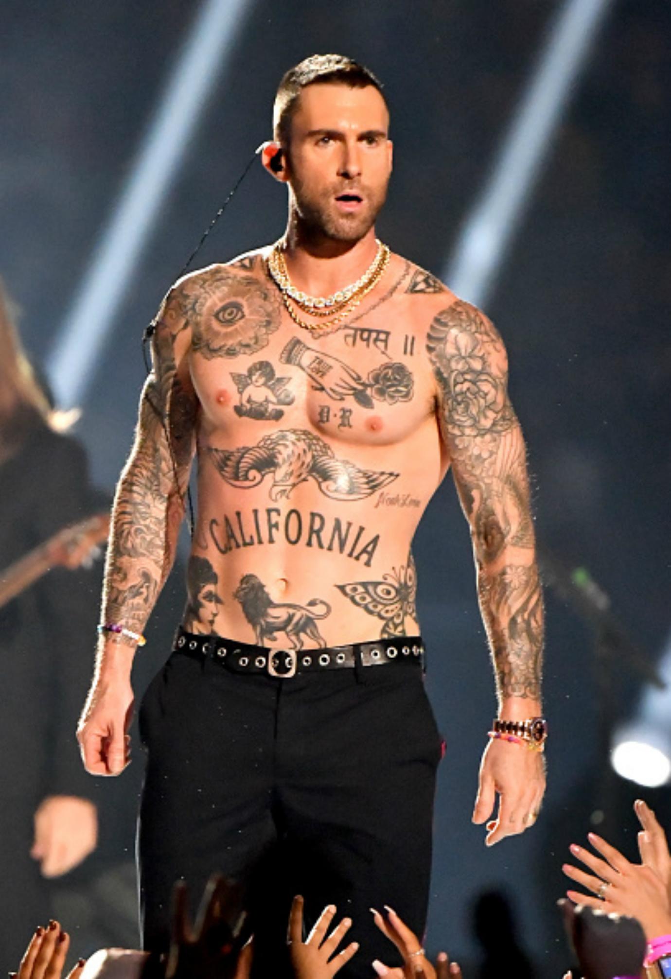 Adam Levine performs on stage.