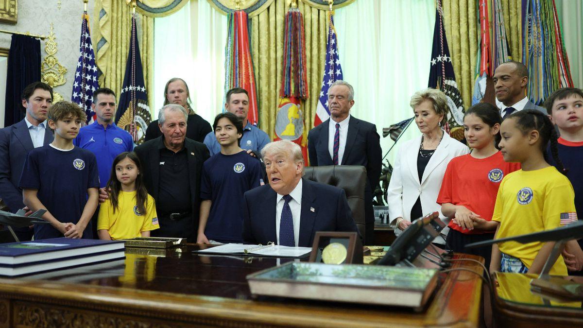 image of The president asked the child about her ability to jump and reach the net.