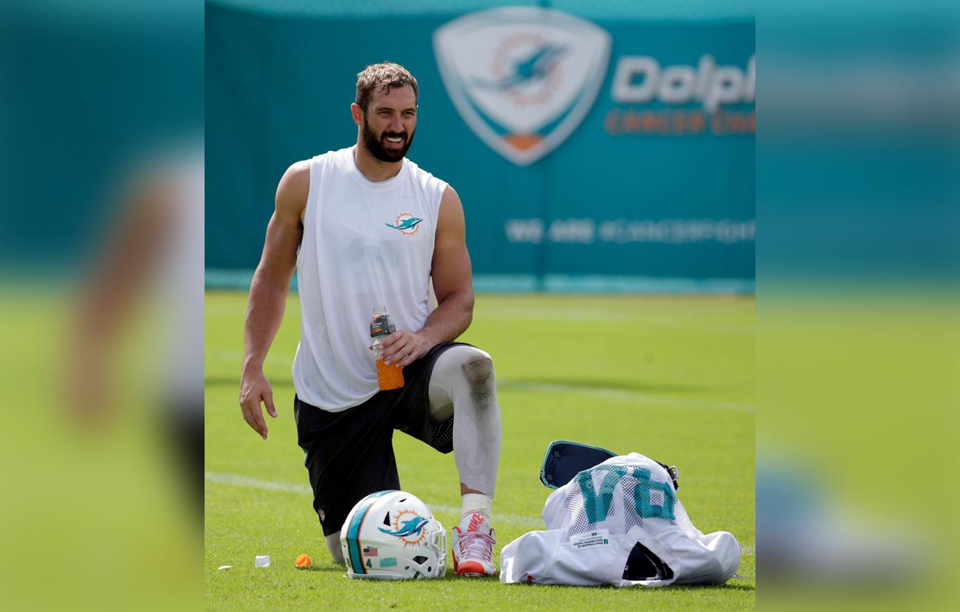 Jordan Cameron Looks Tired During Practive in White Miami Dolphins Tank As He Takes A Knee to Rest and Drink a Sports Drink