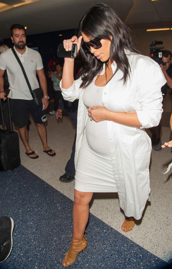 Kim Kardashian Flaunts Baby Bump In White Dress