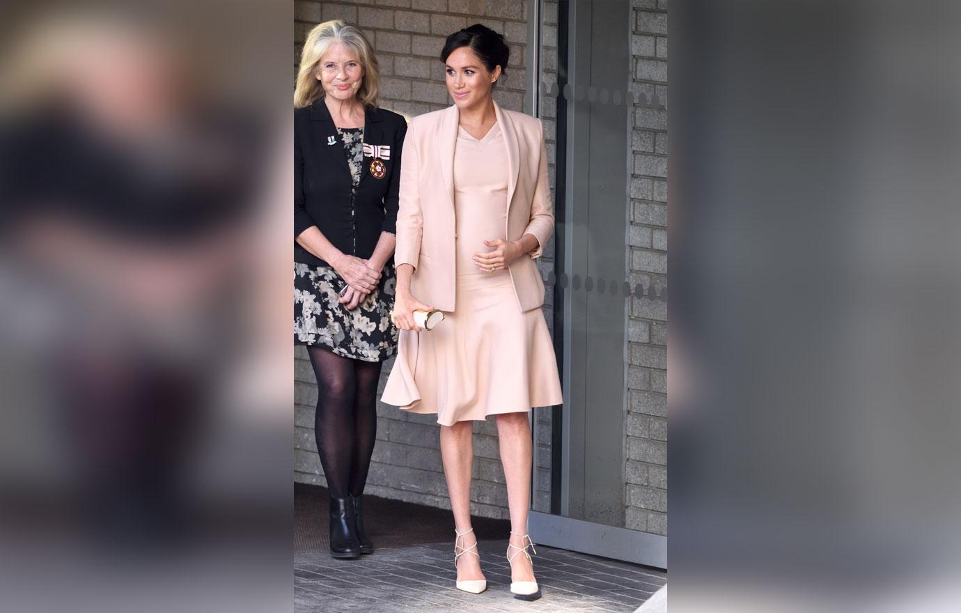 Pregnant Meghan Markle Cradles Stomach During Visit To Royal Theatre