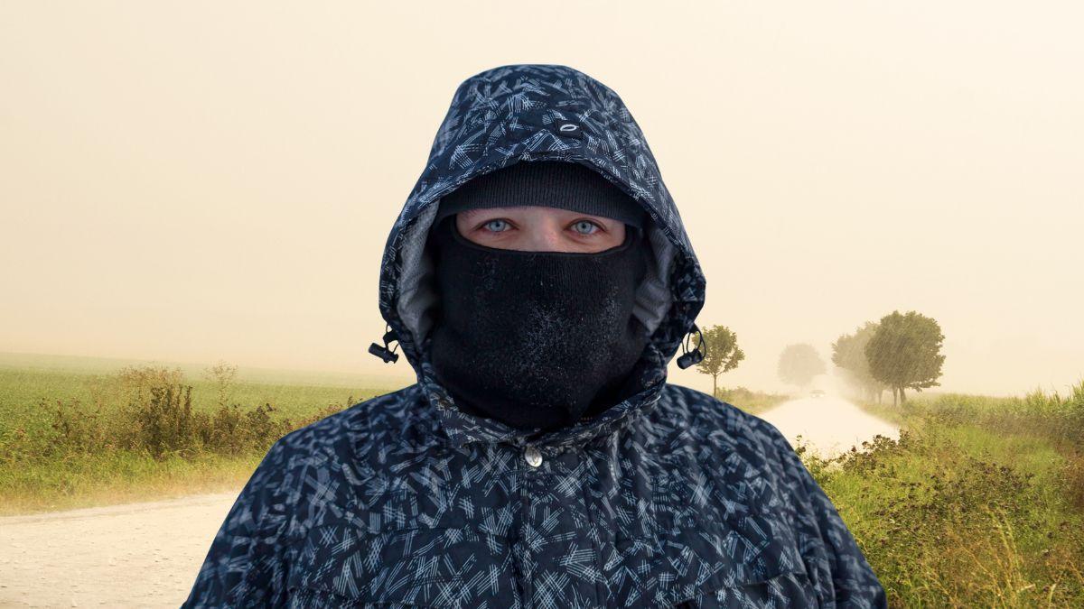 Photo of a guy wearing camouflage clothing and a black balaclava.