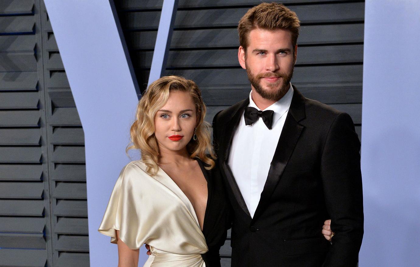 Miley Cyrus wore a plunging black sequined Saint Laurent gown, which she accessorized with Bulgari jewelry, with Liam Hemsworth in a classic black tux.