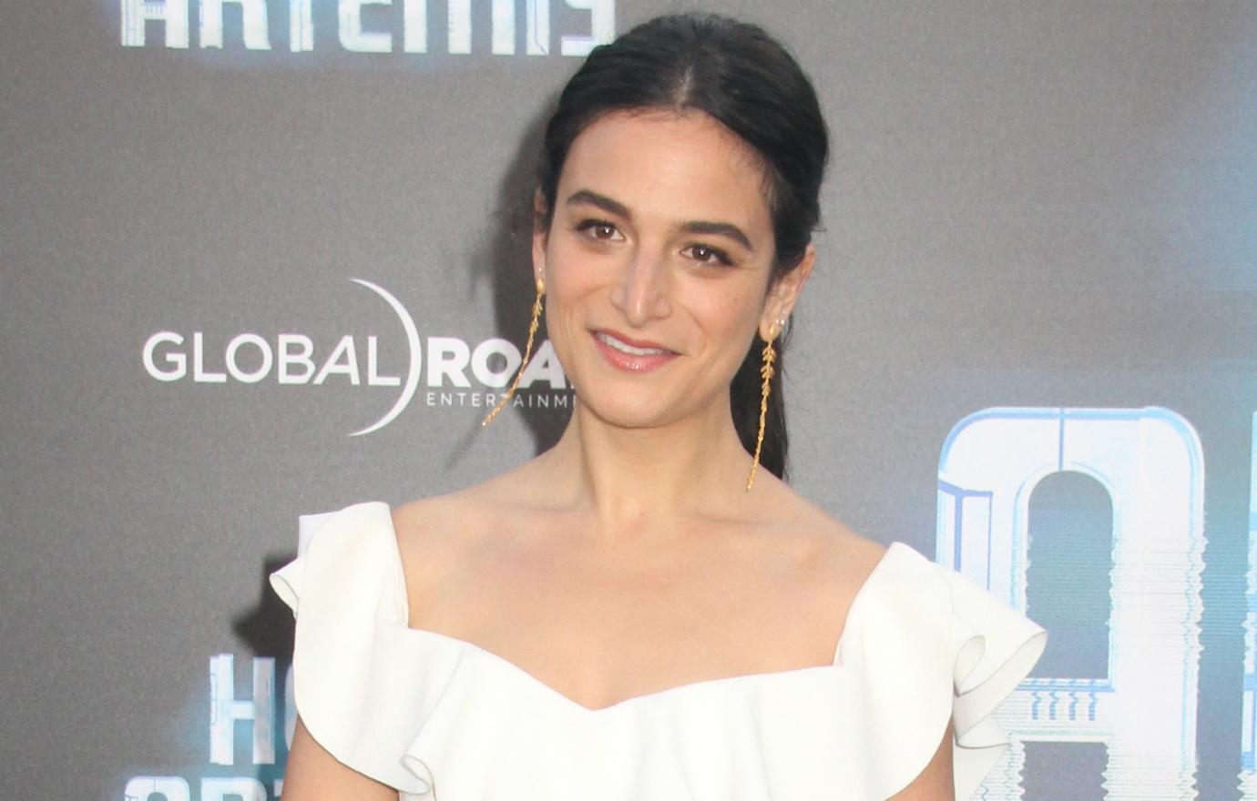 Jenny Slate stunned in a white gown with a frilly neckline at the premiere of Hotel Artemis.