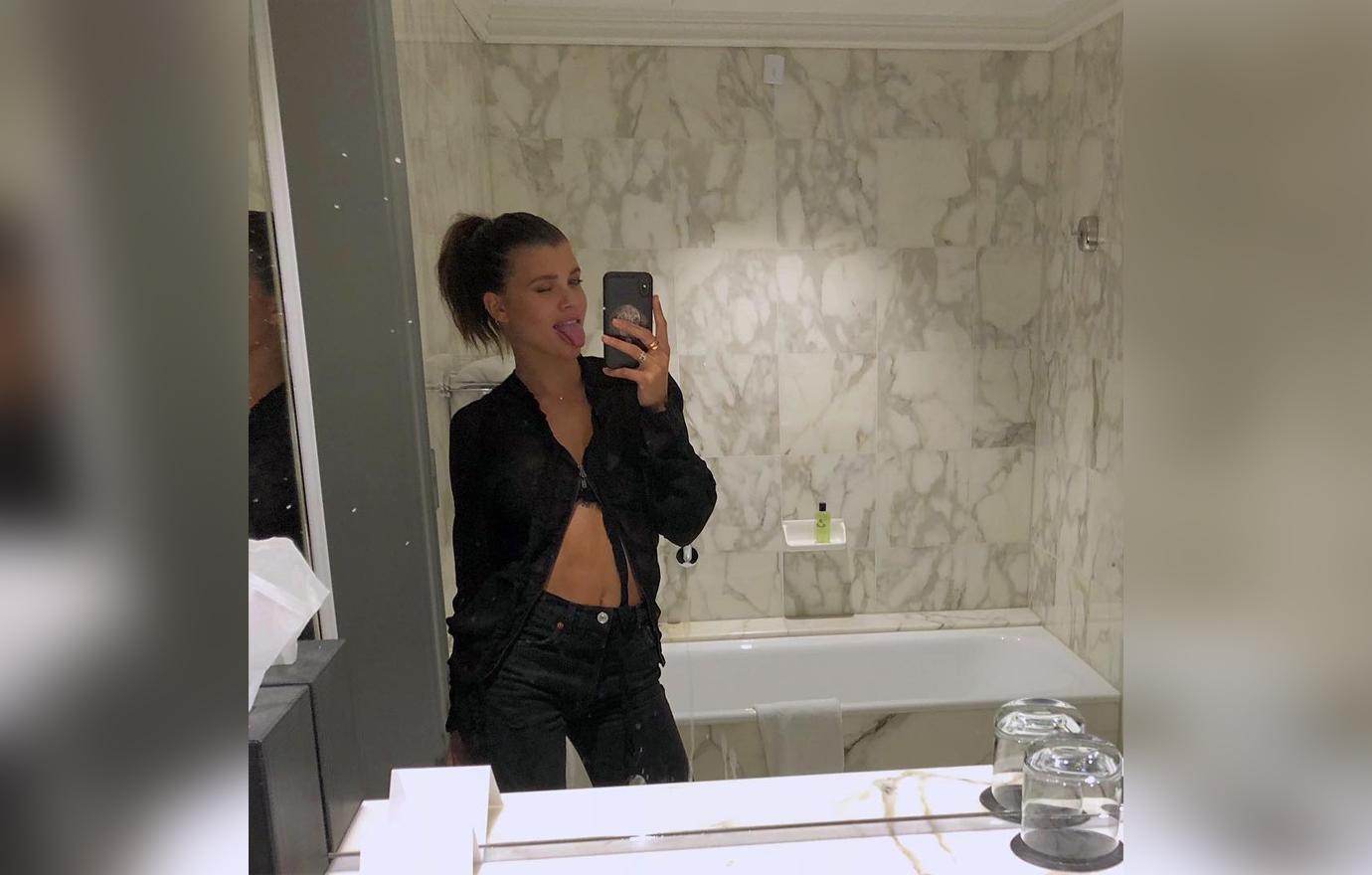 Sofia Richie Mirror Selfie In Black Bra and Jacket with Jeans Sticking Tongue Out