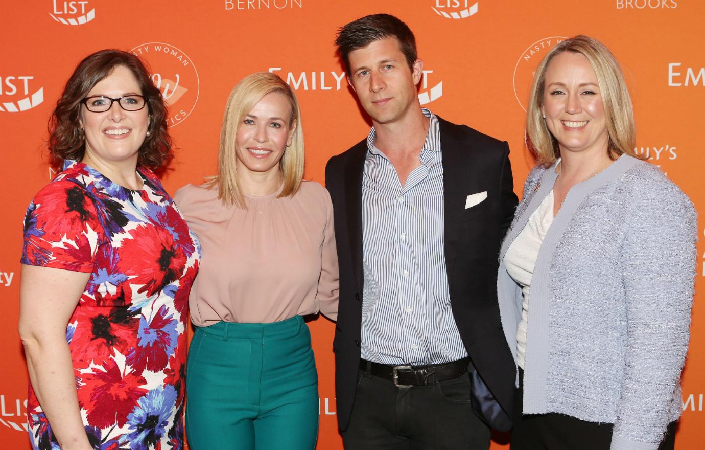 Paul Bernon, in blue shirt and black suit, stands with three other women on the red carpet.