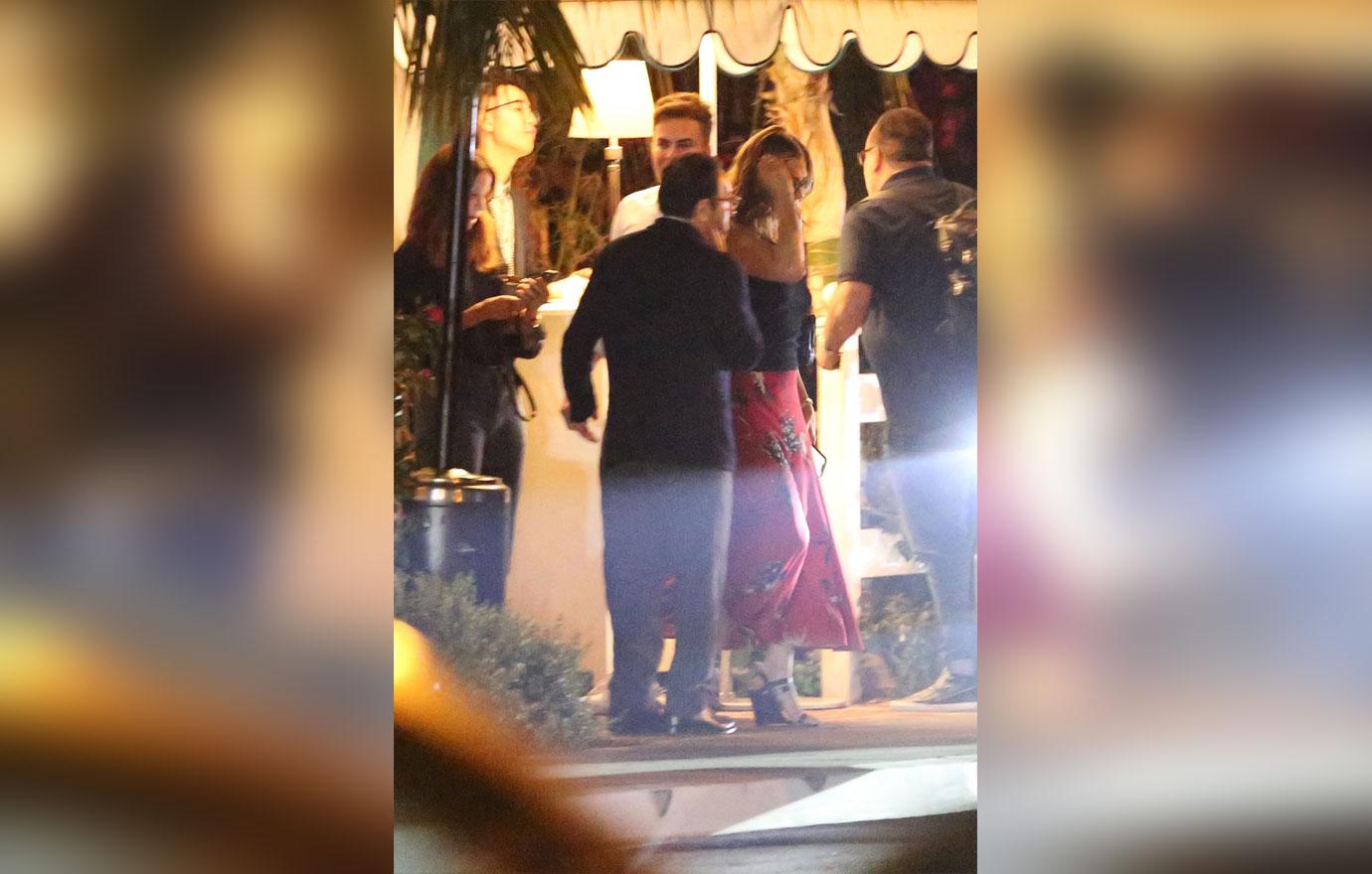 Jennifer Aniston kisses a male friend goodbye after having dinner in Los Angeles. The 50 year old actress is wearing a red skirt with a black top. She dined at the restaurant with a few friends including a mystery man who she gave a hug and a kiss to on the cheek before departing.