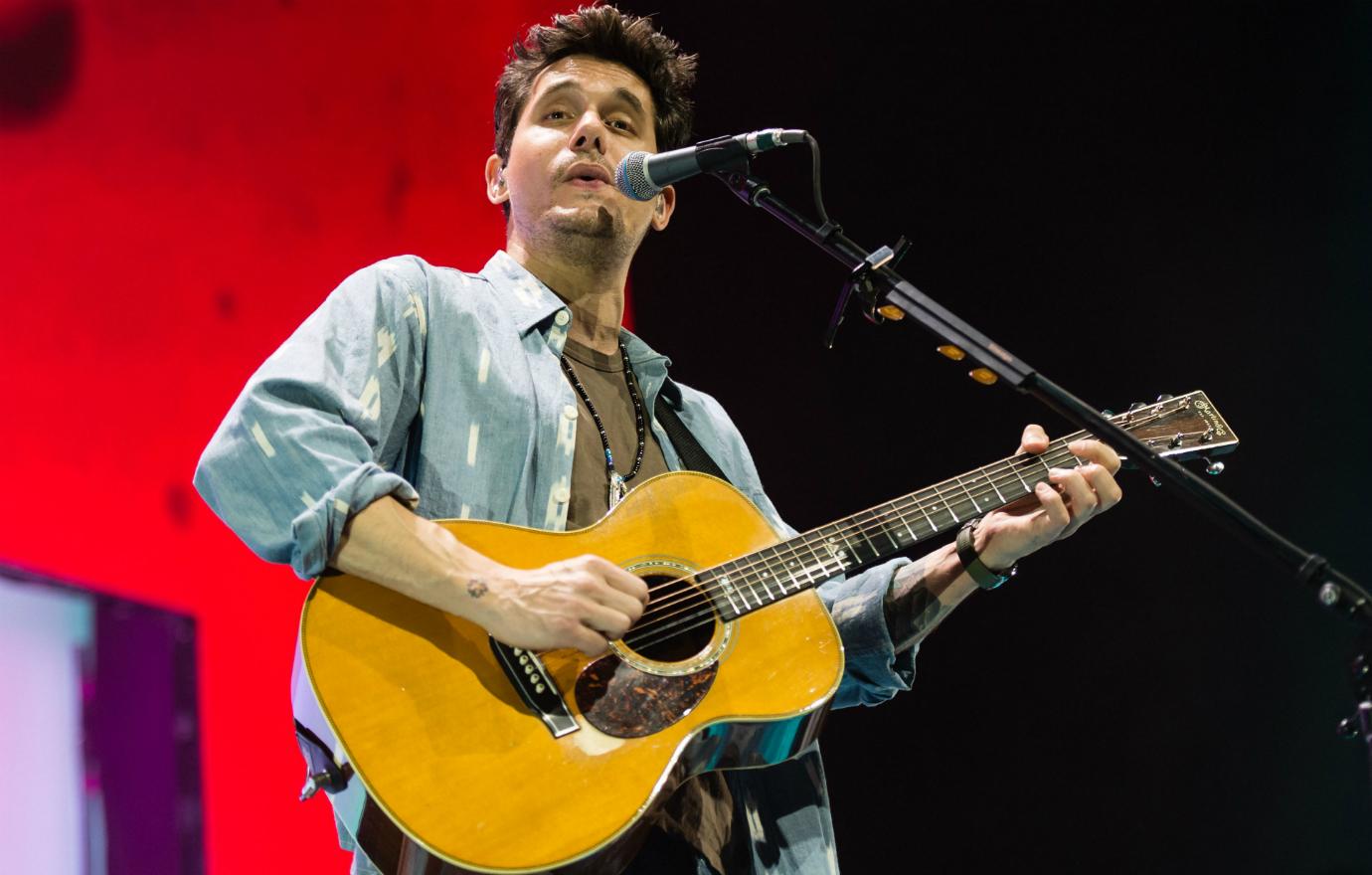 John Mayer strummed his guitar at a recent concert, and wore a blue denim buttoned-down shirt.