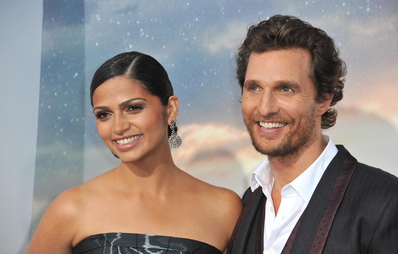 Camila Alves in a silver dress and Matthew McConaughey in a grey suit