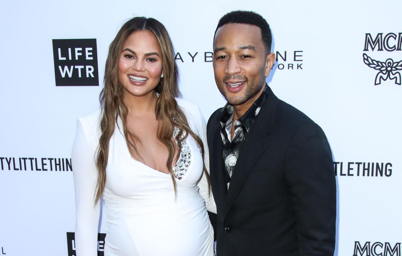 John Legend and (a very pregnant) Chrissy Teigen pose