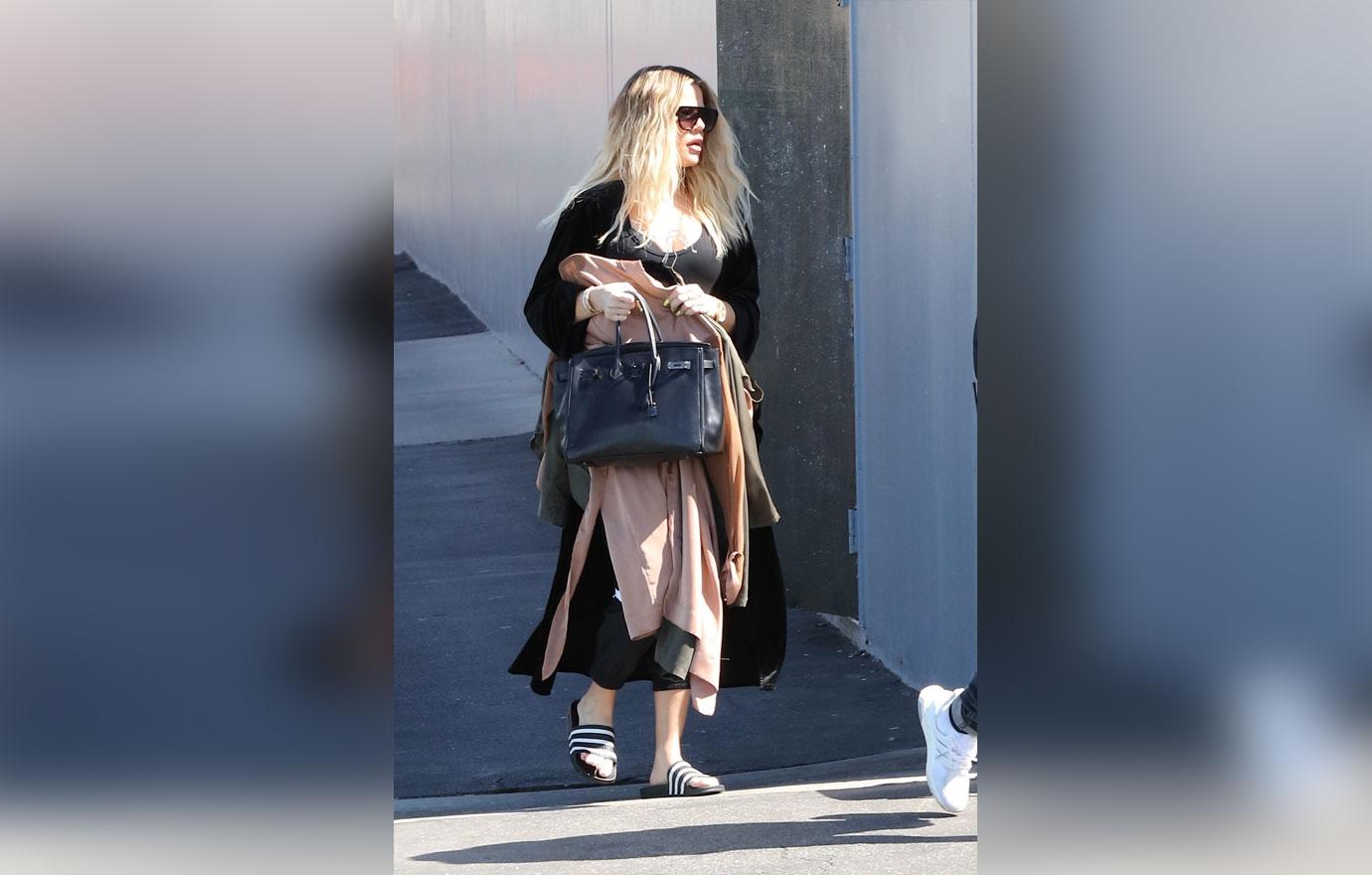 Khloe Kardashian covers baby bump