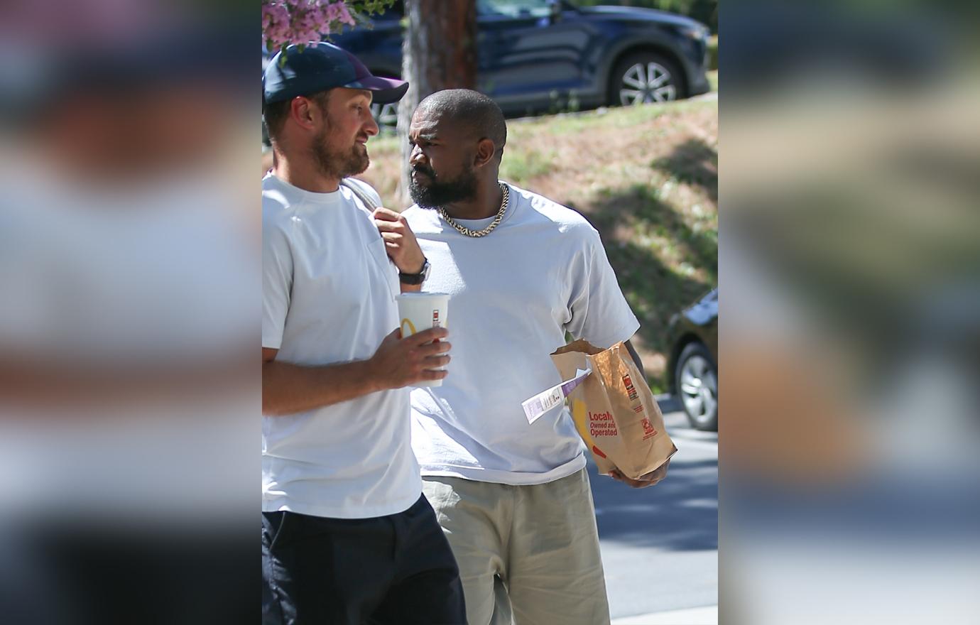 Kanye West carries a bag of fast food from his beloved McDonalds as he heads to a meeting in Calabasas.