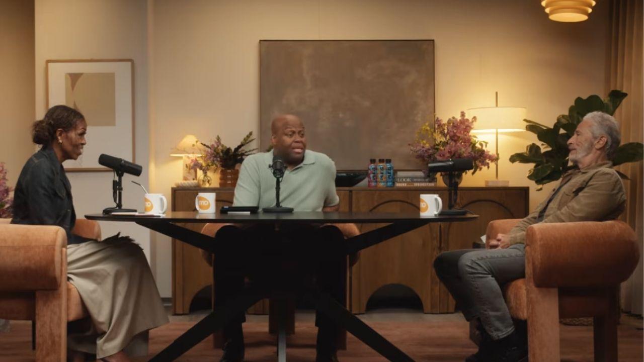 A photo of Michelle Obama, Craig Robinson, and Jon Stewart