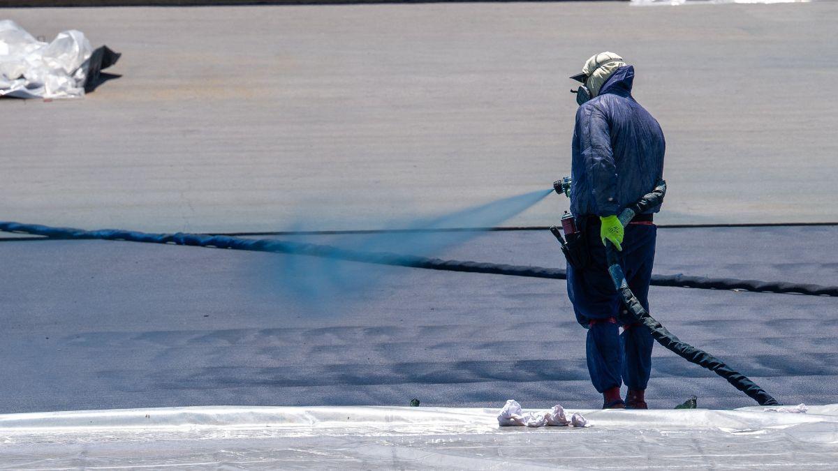 A photo of a worker spraying the Reflecting Pool