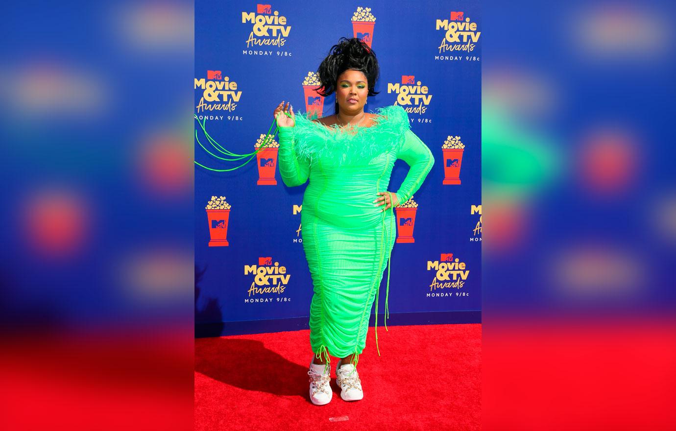 Lizzo wears a lime green dress.