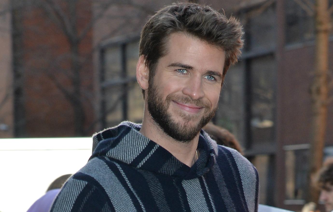 Liam Hemsworth smiled out and about at home in a Baja sweatshirt.