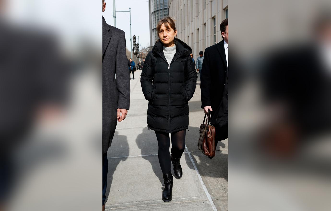 Allison Mack Walking From Court Looking Content Wearing Black Winter Coat and Tights Alongside Lawyers