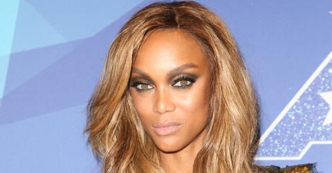 Tyra Banks wears a bronze sequined butterfly sleeve dress, smokey eyes, and long wavy blonde hair at the 2017 America’s Got Talent taping.