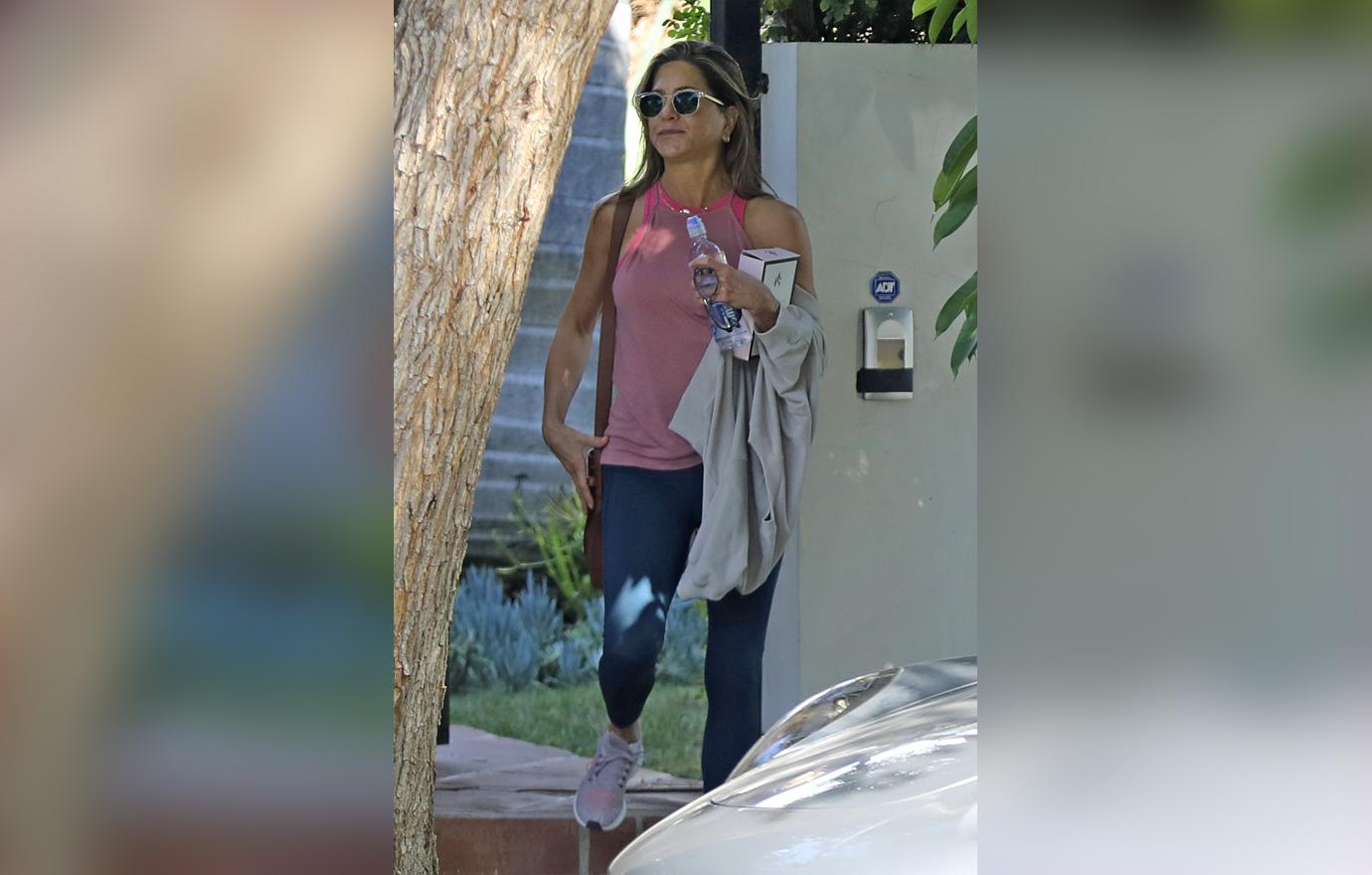 Jennifer Aniston Wearing Sunglasses Pink Tank Top and Navy Leggings Flaunts Body