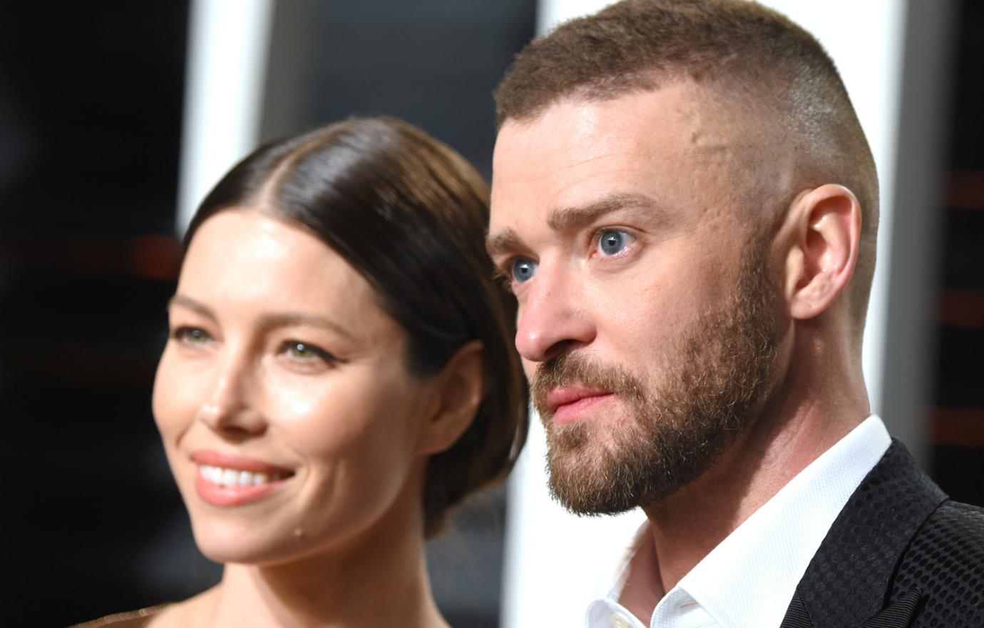 A close up of Jessica Biel in a gown standing next to Justin Timberlake who wears a black jacket and white shirt.