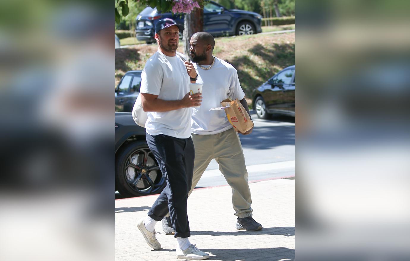 Kanye West carries a bag of fast food from his beloved McDonalds as he heads to a meeting in Calabasas.