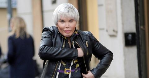 Rodrigo Alves in a black leather jacket, black jeans and patterned black shirt walks down the street.