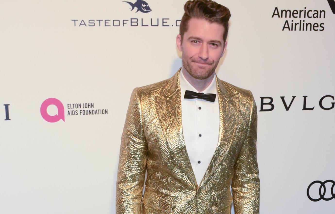 Matthew Morrison wearing a gold jacket