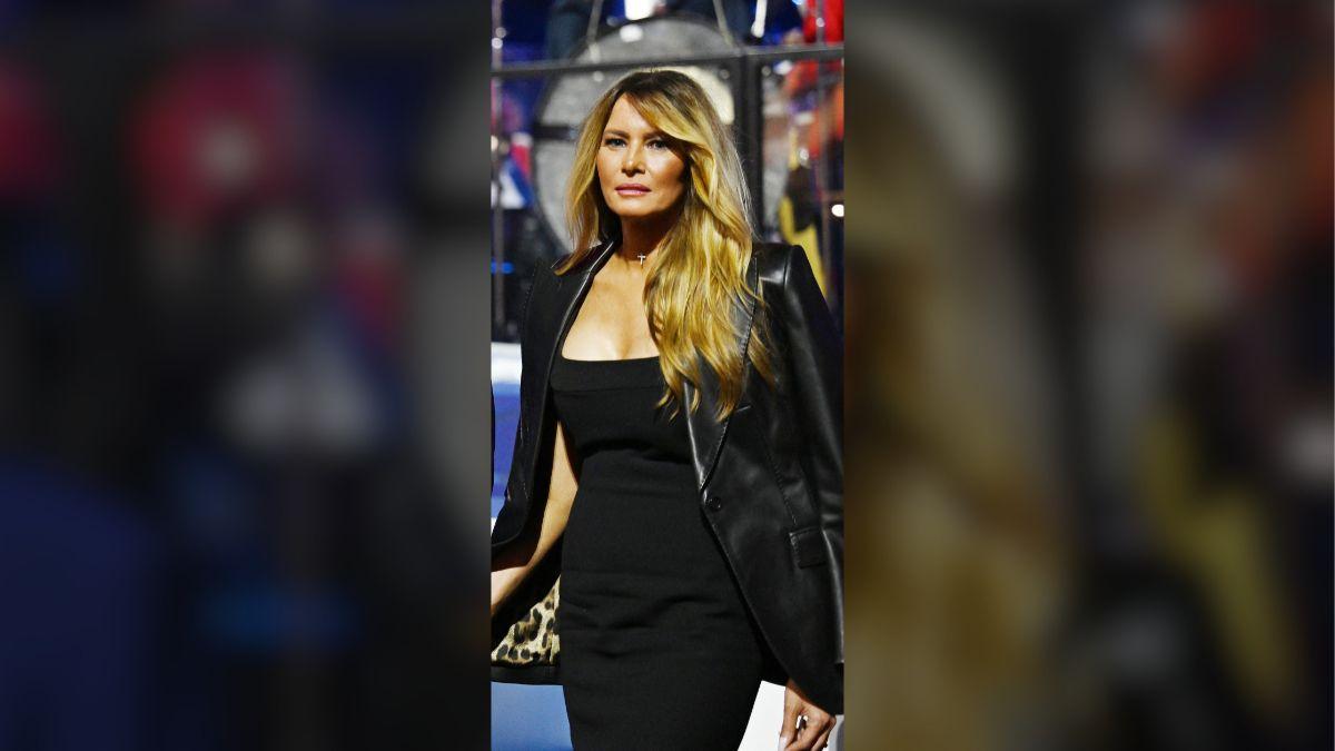 image of Melania paired a fitted black dress with a leather blazer draped over her shoulders.