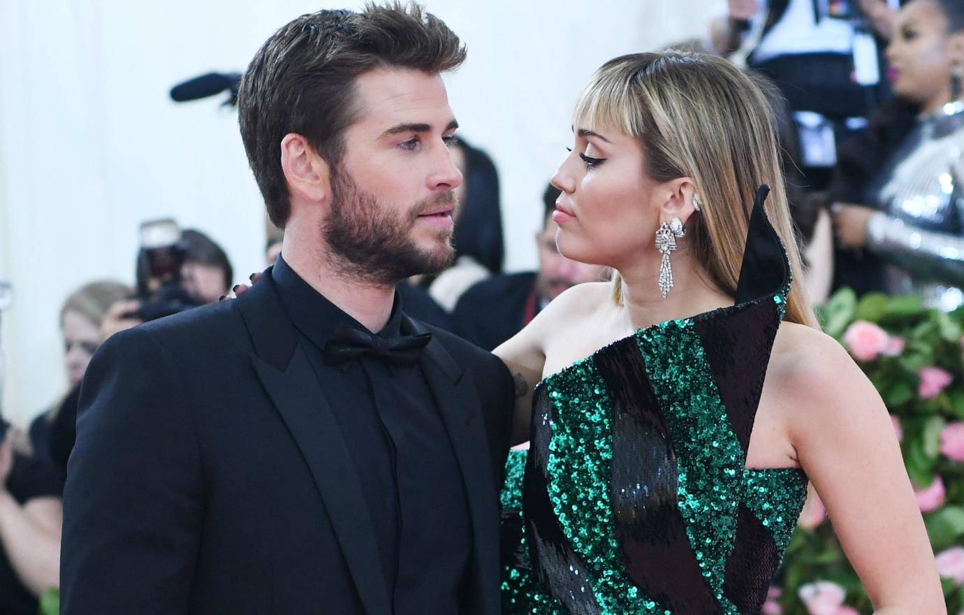 Miley Cyrus wore a dazzling green and black sparkly off the shoulder dress, while Liam Hemsworth sported a black tux, black shirt and black bow tie.