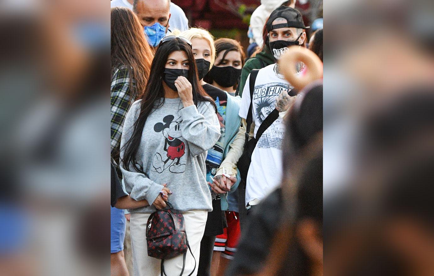 kourtney kardashian and travis barker take their modern family on a fun day out at disneyland