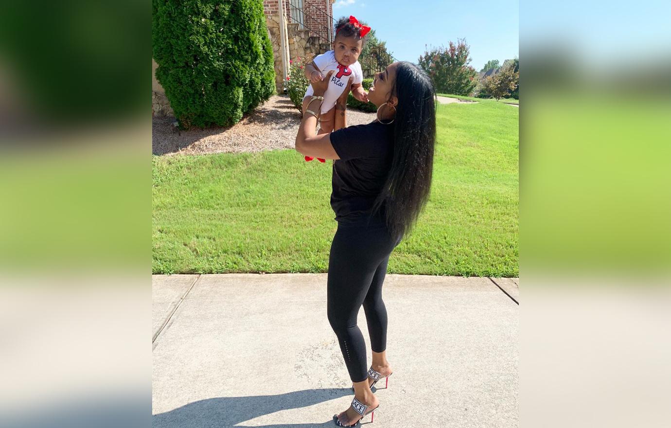 Porsha Williams In Black Leggings Smiles As She Lifts Baby Pilar In The Air Outside