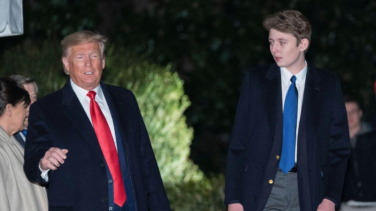Image of Barron Trump and his father leave the White House for the National Defense Authorization Act for Fiscal Year 2020 signing ceremony
