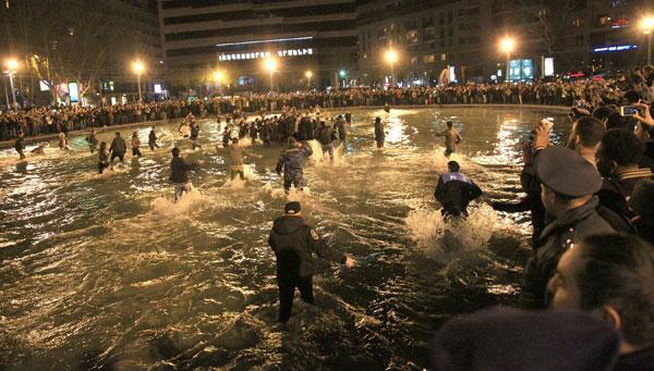 Kanye West jumps into water as fans, cops, jump in along with the soaking wet rapper at last minute concert in Armenia. Kanye decided to organize the show at literally 9pm on late Sunday night and by using social media over 3,000 screaming fans showed up at the duck pond to watch him perform at nearly 1:20am local time. Kanye was on stage singing his hit when his mic started to short out as the crowd noticed. Minutes later he asked a section of the crowd if they could see him and after realizing they could not, he jumped literally into the middle of the duck pond and drops his mic into the water due to it being too wet and ruined. He is then literally surrounded by the fans as they run into the water with him as his bodyguard Pascal is spotted running to his side along with the Armenian National Guard and Police all getting soaking wet to retrieve the rap star. Kanye was then brought closer as a fan tried to touch his hand, the cops pushed him and Kanye reacted to holding the cops back to let the fan get a photo with him in the pond too! Madness occurs in a stampede style follow as Kanye is finally pulled to the top of the pond and is guided with his entourage out of the park with thousands running and following him out of the concert. Kim Kardashian was shown on side stage watching her man perform and was all smiles