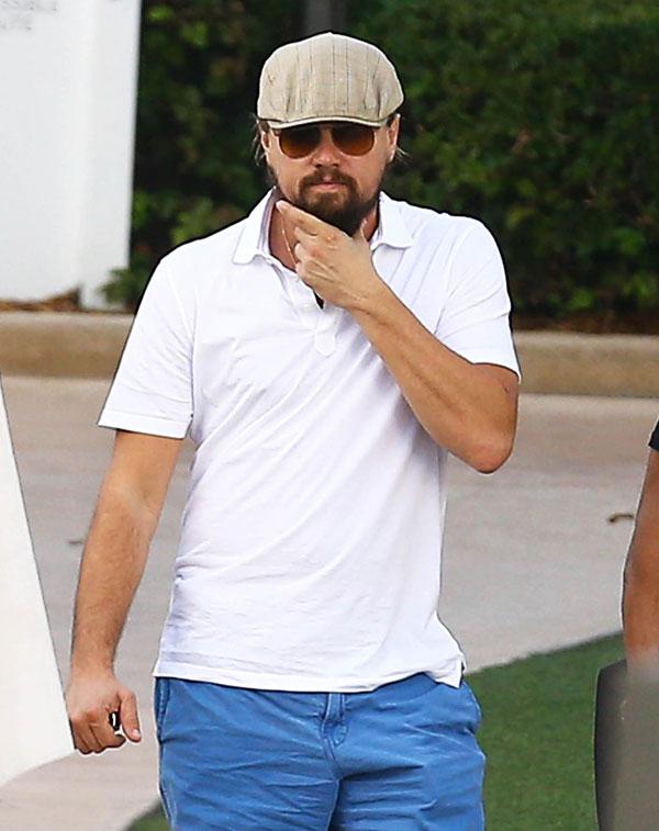 //Leonardo DiCaprio strokes his bushy beard while out and about at Art Basel with friends on December   in Miami Florida