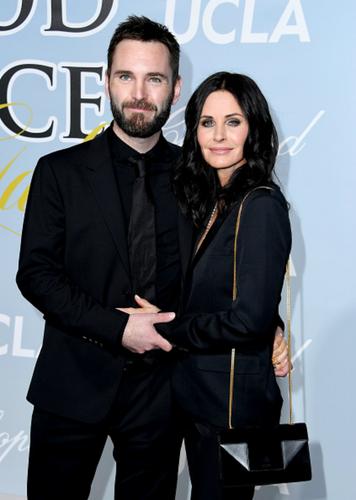 Courtney Cox and Johnny McDaid pose for a photo.