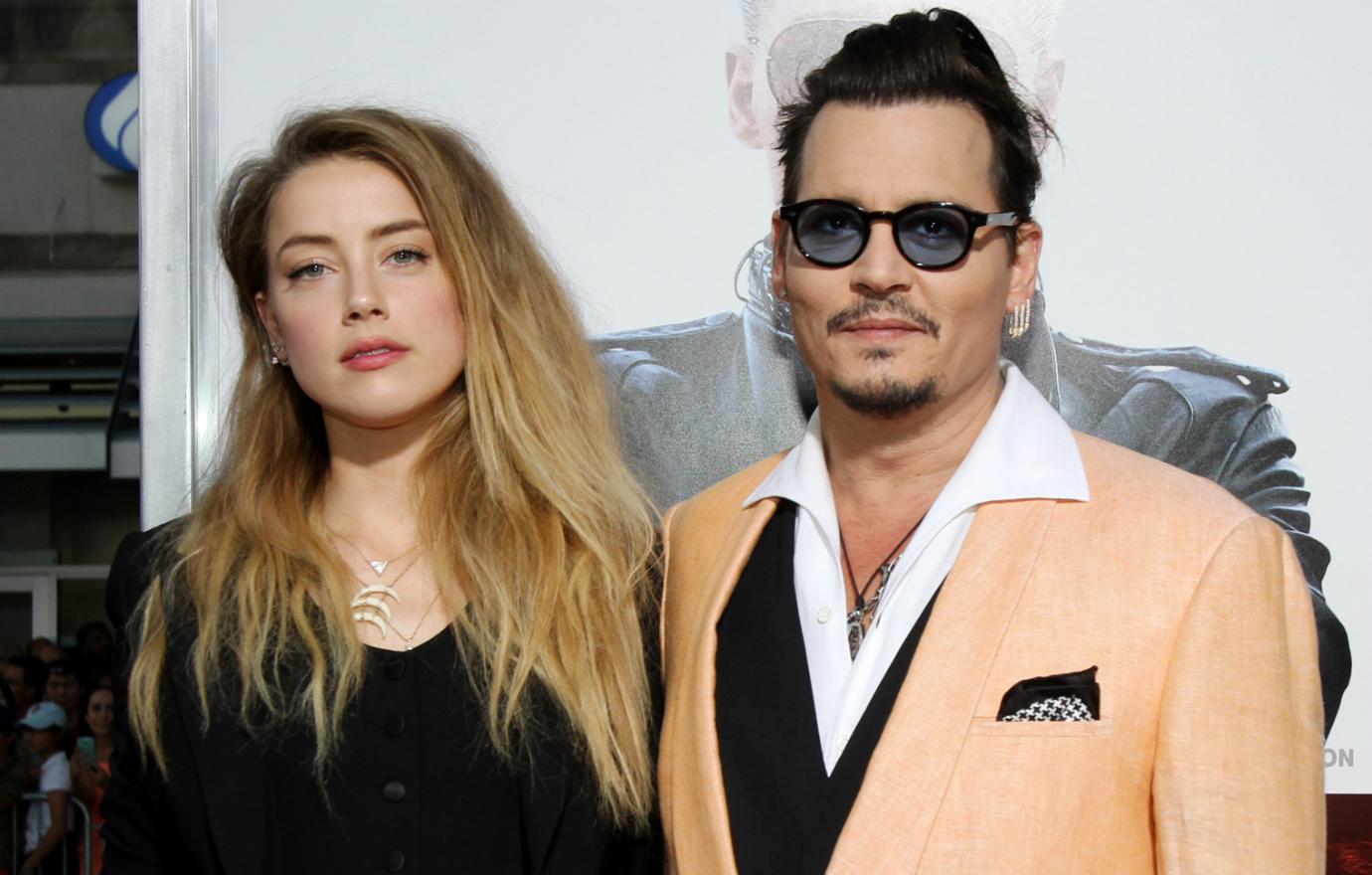 Johnny Depp wore a pink blazer over a black vest and white collared shirt while Amber Heard sported a navel-bearing black pantsuit with matching blazer.