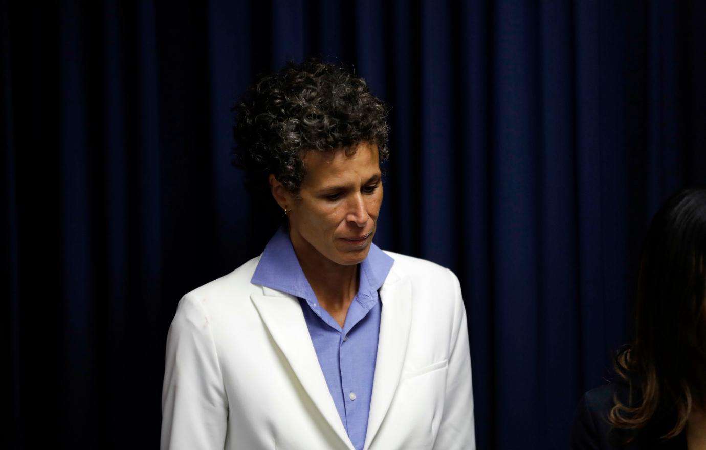 Andrea Constand wears a white jacket and blue shirt.