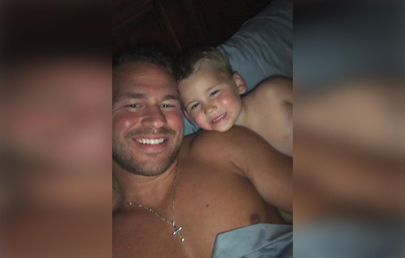 Nathan Griffith Smiling and Laying In Bed With Son Kaiser