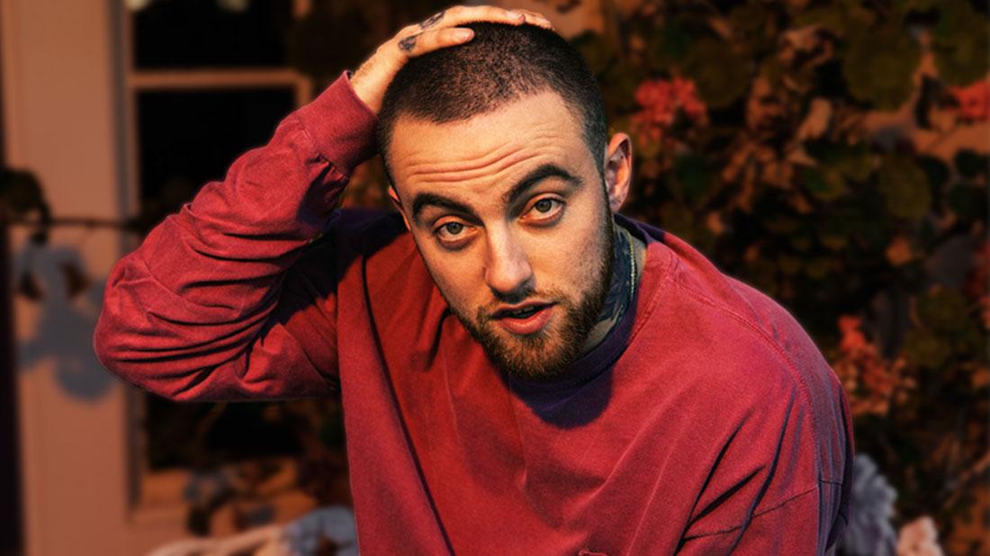 Mac Miller With Hand On His Head Wearing Red Sweatshirt