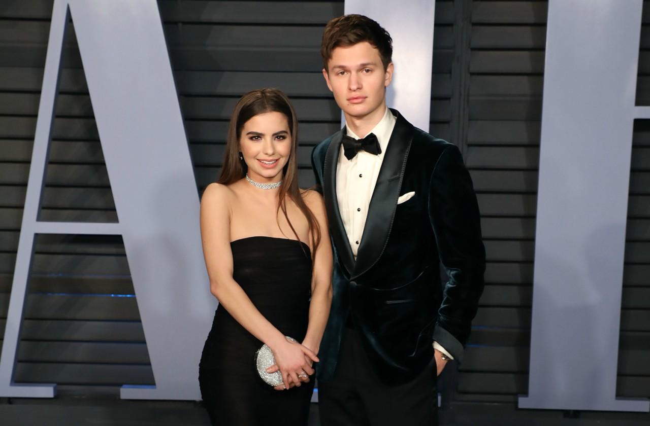 Ansel Elgort and Violette Komyshan, both dressed in black, pose at the Vanity Fair Awards red carpet