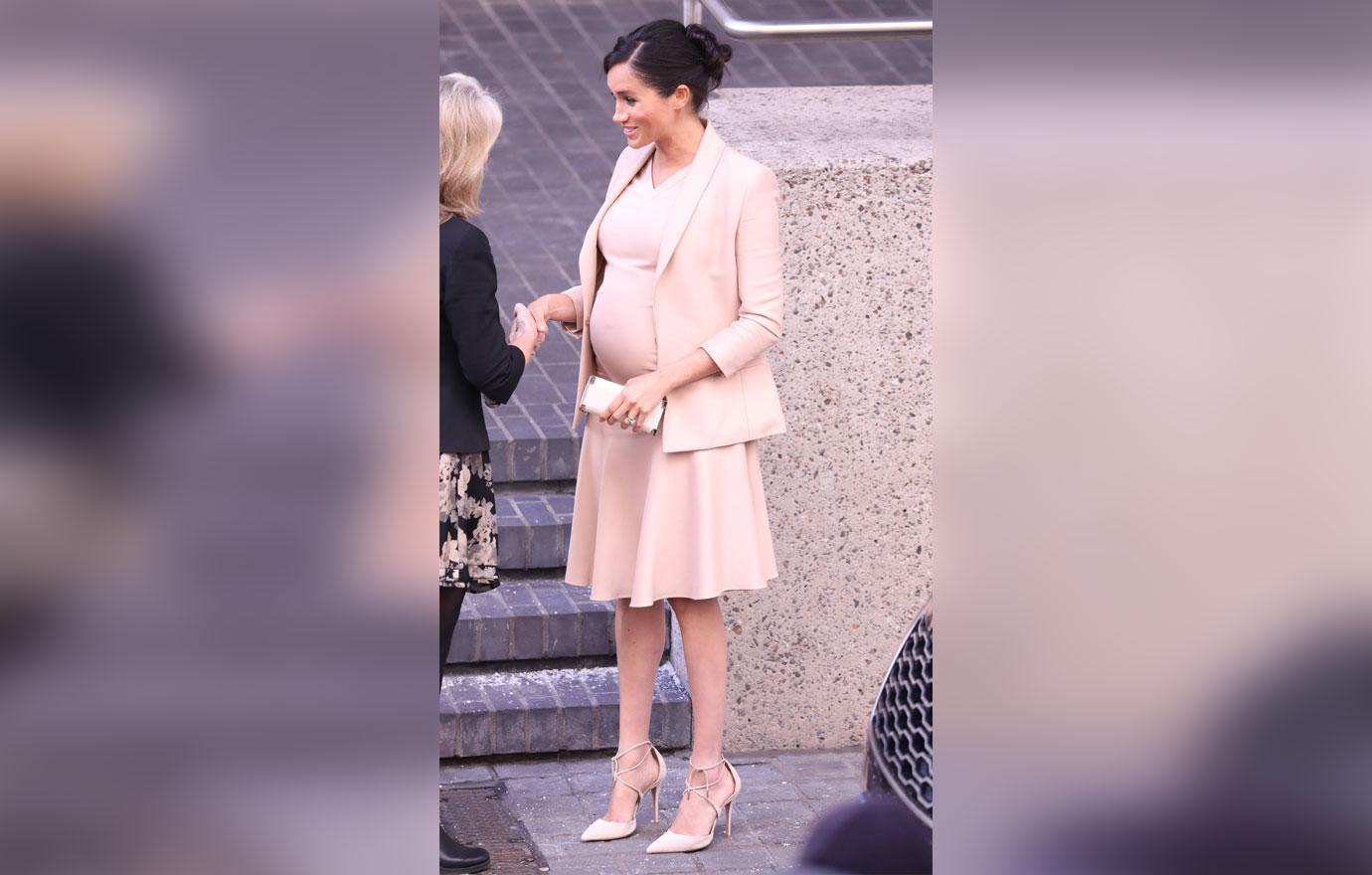 Pregnant Meghan Markle Cradles Stomach During Visit To Royal Theatre