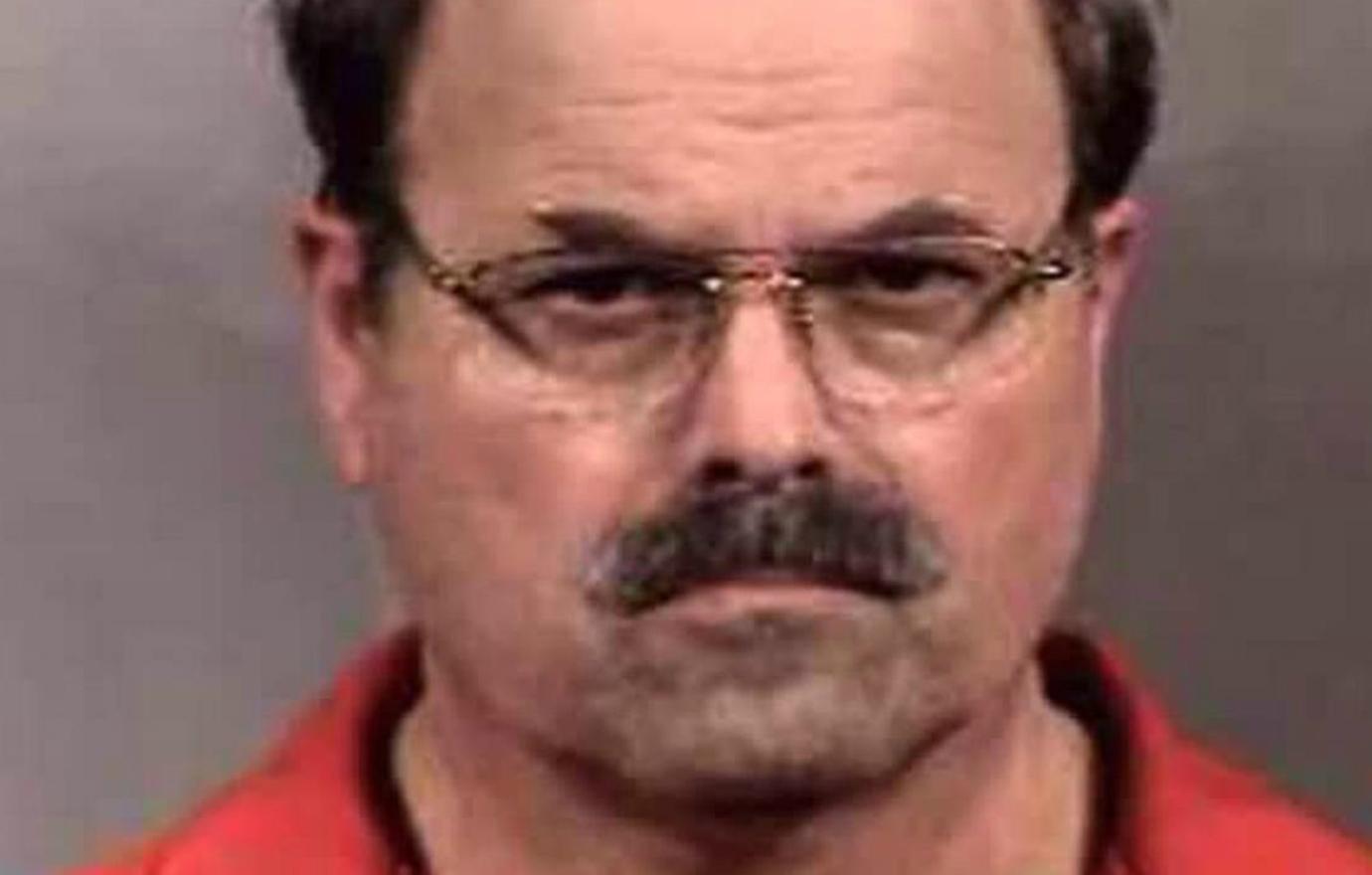 Dennis Rader stares into the camera for his mugshot.