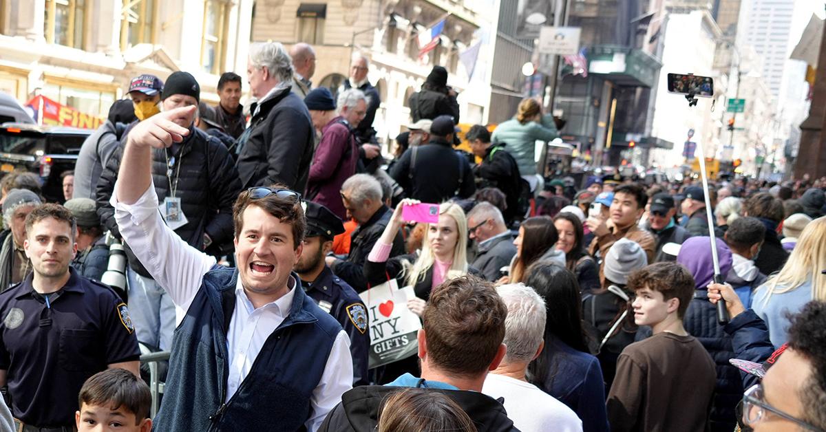 maga supporter trump arraignment protest rips flag