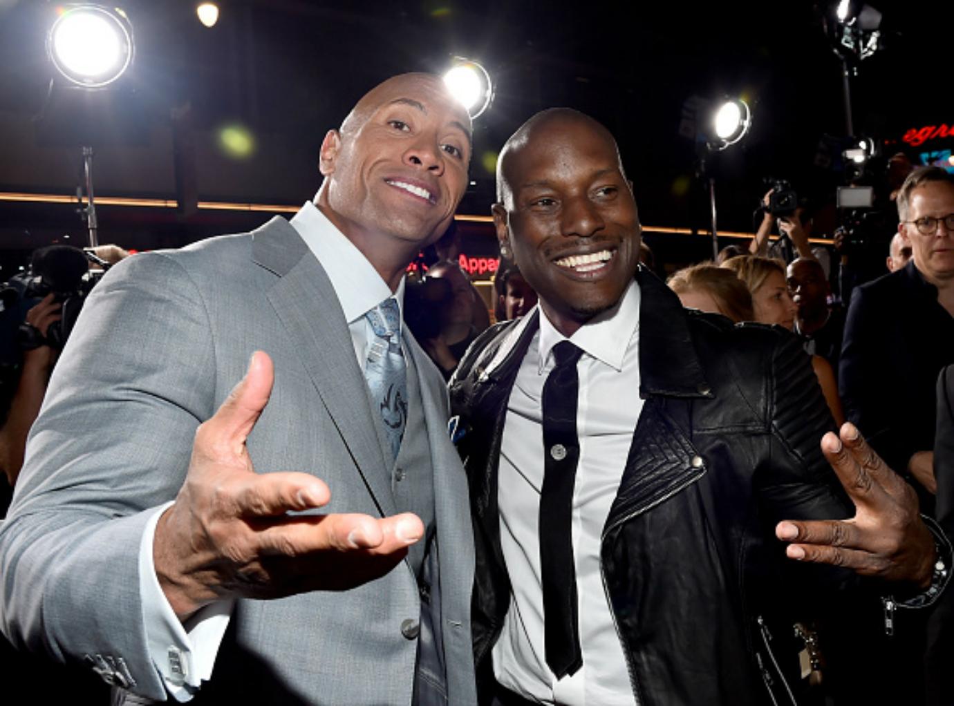 Tyrese Gibson and Dwayne Johnson pose for a photo.